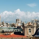 Skyline of Valencia with historic architecture and towers under a bright sky.